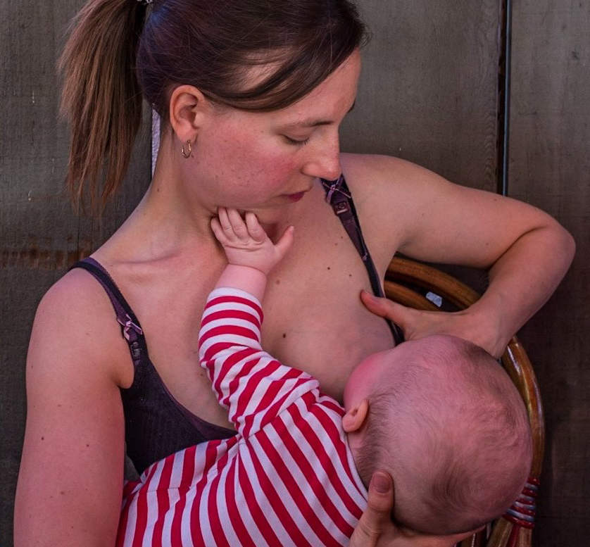 A mother breastfeeds her baby