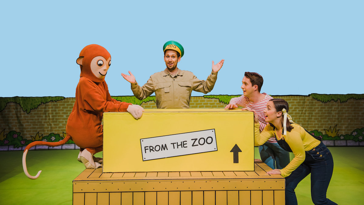 An actor dressed as a monkey, an actor dressed as a zookeeper and two actors dressed as children on the set of theatre show Dear Zoo