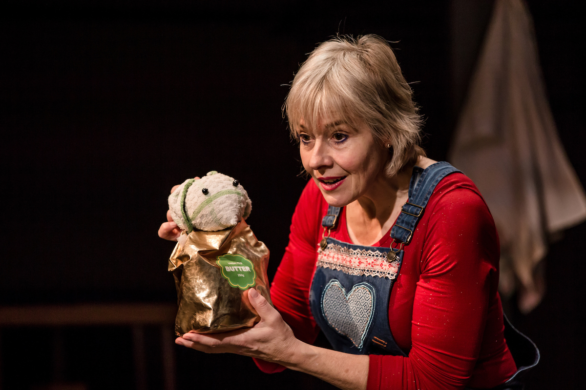 An actor holds a puppet mouse