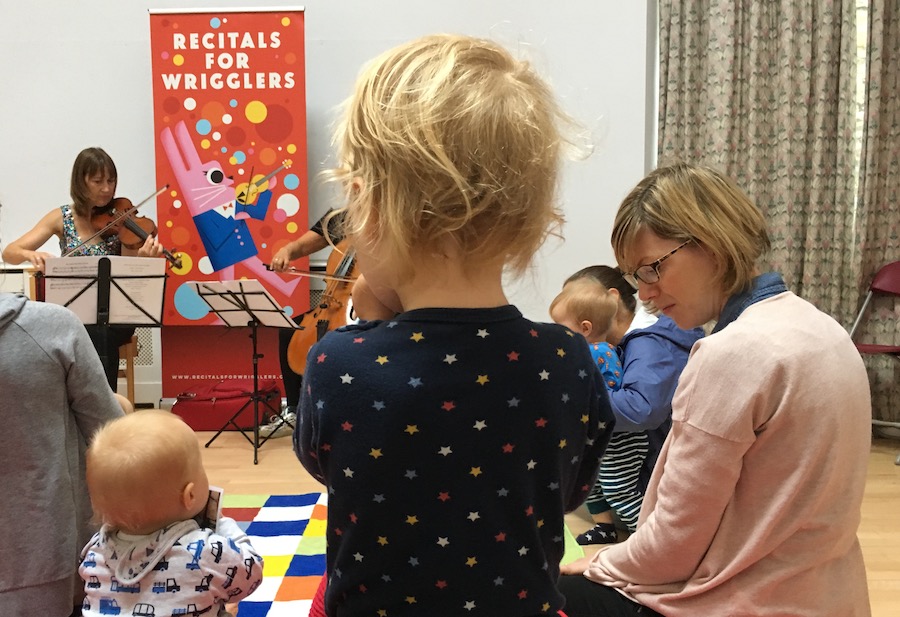 A toddler and some babies listen to a classical concert at the Edinburgh Festival Fringe